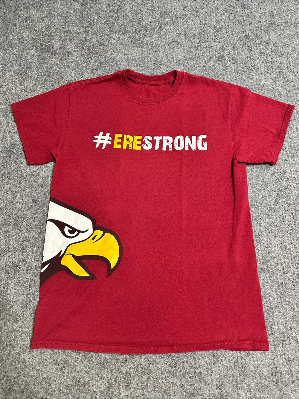 This is a maroon short-sleeve crewneck T-shirt featuring an eagle head logo